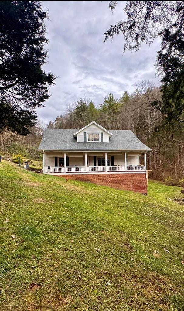 196 Goodwin Rd, Cedar Bluff, VA 24609 - view of front facade featuring covered porch, a front lawn, and a shingled roof
