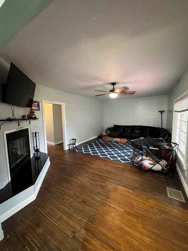 196 Goodwin Rd, Cedar Bluff, VA 24609 - living area with wood-type flooring, ceiling fan, baseboards, and a glass covered fireplace