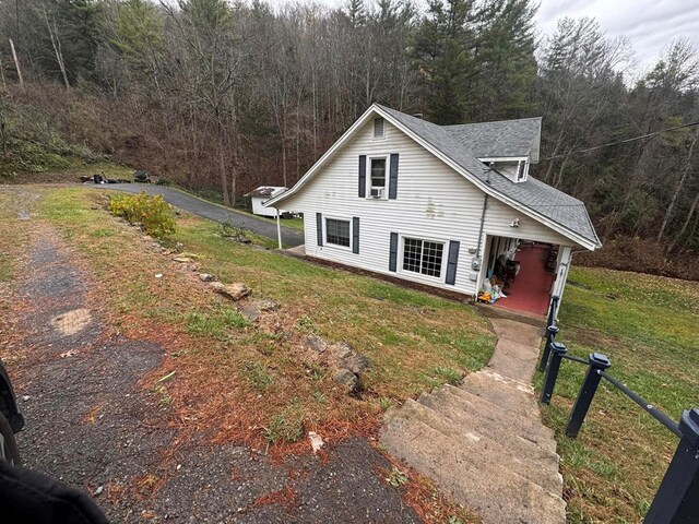 196 Goodwin Rd, Cedar Bluff, VA 24609 - view of side of property featuring a forest view, a yard, and roof with shingles