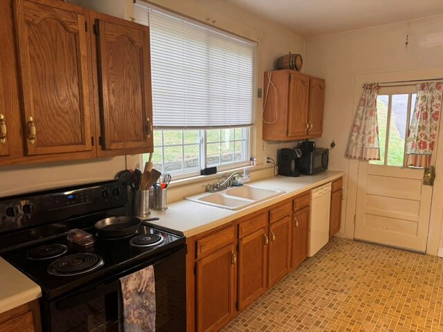 196 Goodwin Rd, Cedar Bluff, VA 24609 - kitchen with black appliances, a sink, light countertops, and brown cabinetry
