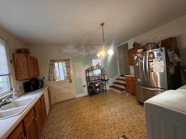 196 Goodwin Rd, Cedar Bluff, VA 24609 - kitchen with freestanding refrigerator, a sink, brown cabinets, washer / clothes dryer, and healthy amount of natural light