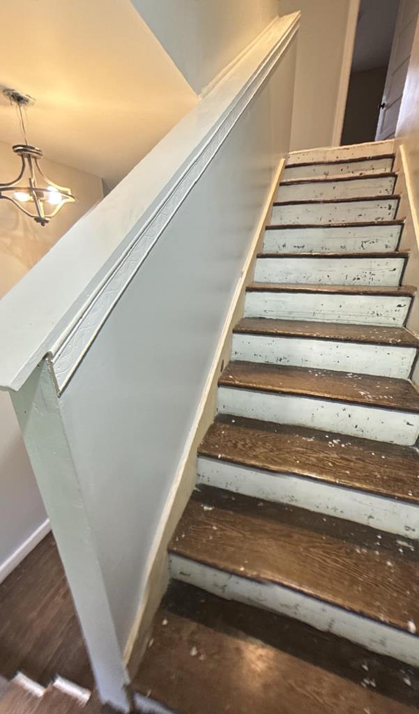 196 Goodwin Rd, Cedar Bluff, VA 24609 - staircase with baseboards and a chandelier