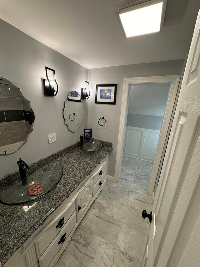 196 Goodwin Rd, Cedar Bluff, VA 24609 - full bath featuring marble look tile flooring, double vanity, and baseboards