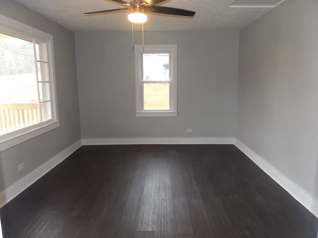 unfurnished room with ceiling fan, dark wood-type flooring, and a textured ceiling