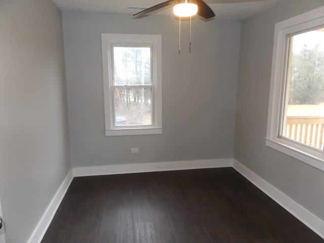 unfurnished room featuring ceiling fan and dark hardwood / wood-style flooring