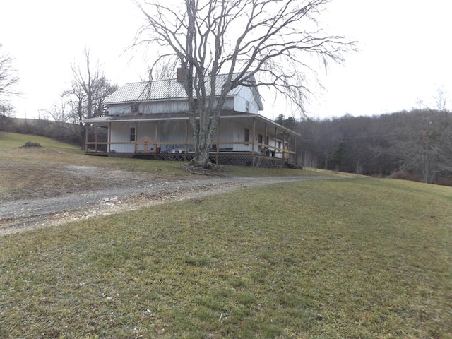 548 Archie Ave, Laurel Fork, VA 24352 - view of front of property with covered porch, a front yard, a chimney, driveway, and metal roof