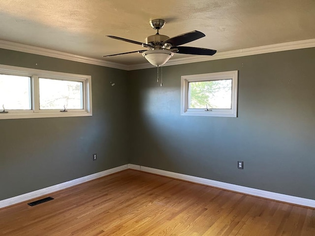 empty room featuring crown molding, a textured ceiling, ceiling fan, and light wood-type flooring