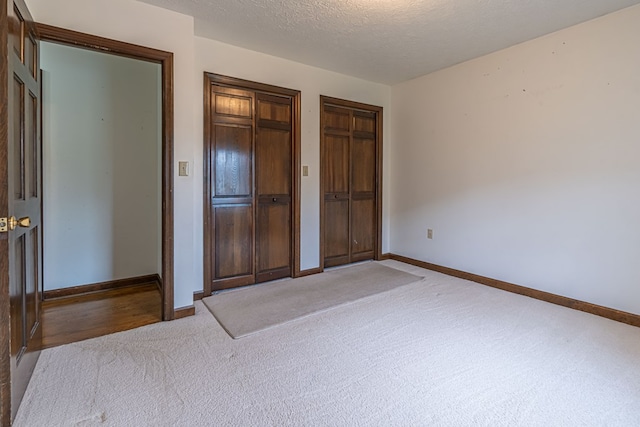 19464 Triple Crown Dr, Abingdon, VA 24211 - unfurnished bedroom with carpet flooring, multiple closets, and a textured ceiling