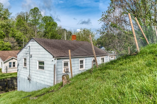 view of outbuilding featuring fence