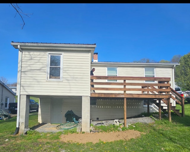 back of house with a lawn and a deck