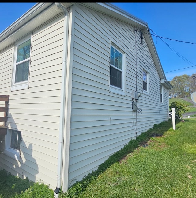 view of side of home featuring a yard