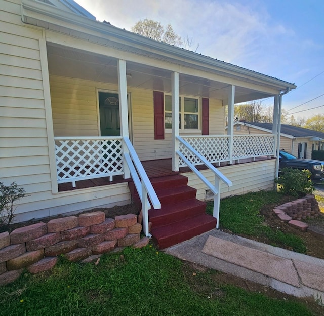 view of exterior entry with a porch