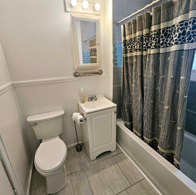 full bathroom featuring shower / bath combo, vanity, and toilet