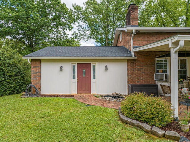 503 Court St, Abingdon, VA 24210 - property entrance featuring a chimney, a lawn, brick siding, and cooling unit