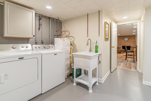 503 Court St, Abingdon, VA 24210 - laundry room featuring independent washer and dryer, water heater, cabinet space, recessed lighting, and a fireplace