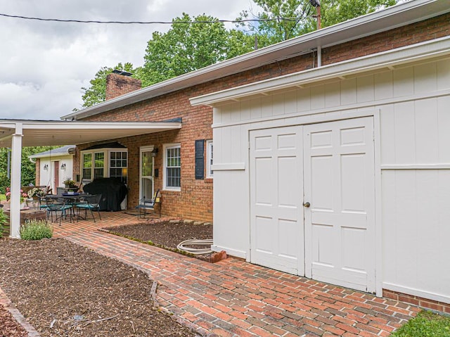 503 Court St, Abingdon, VA 24210 - property entrance with brick siding, a chimney, and a patio area