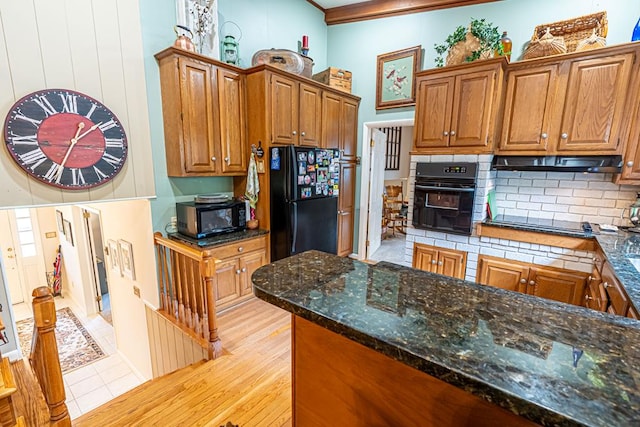 503 Court St, Abingdon, VA 24210 - kitchen featuring black appliances, under cabinet range hood, decorative backsplash, brown cabinetry, and ornamental molding