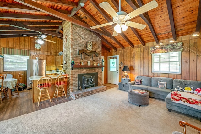 575 Apache Trl, Fancy Gap, VA 24328 - living area with wooden ceiling, wood walls, a ceiling fan, carpet, and wood finished floors
