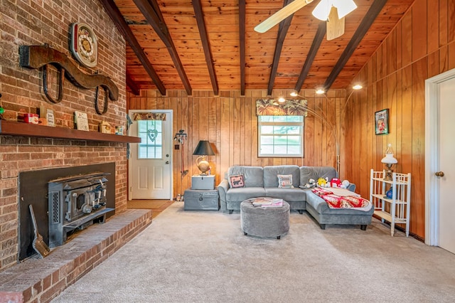 575 Apache Trl, Fancy Gap, VA 24328 - carpeted living area featuring plenty of natural light, wood ceiling, a wood stove, wooden walls, and ceiling fan