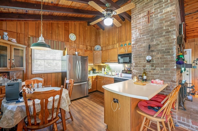 575 Apache Trl, Fancy Gap, VA 24328 - kitchen with freestanding refrigerator, electric stove, wooden walls, a peninsula, and black microwave