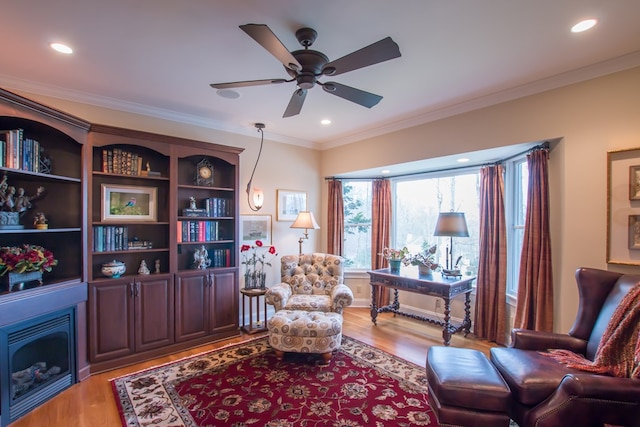sitting room featuring ornamental molding, a ceiling fan, light wood-style floors, and recessed lighting