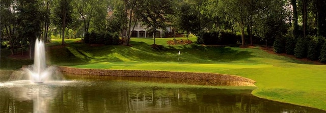 view of property's community featuring a water view and a yard