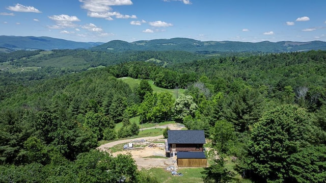 bird's eye view with a forest view and a mountain view