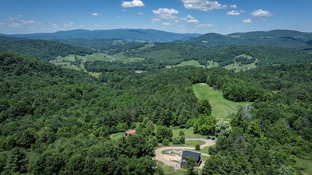 drone / aerial view featuring a forest view and a mountain view