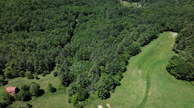 birds eye view of property featuring a forest view