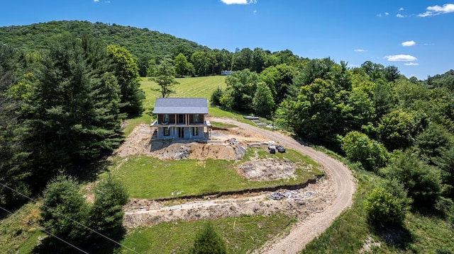 birds eye view of property with a wooded view