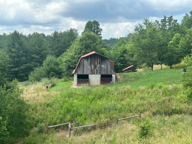 view of barn featuring a wooded view