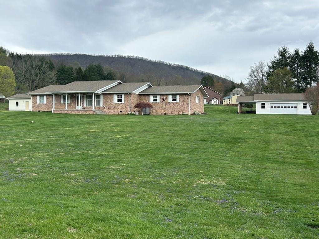 81 Fawn Ln, Rocky Gap, VA 24366 - single story home with a mountain view, a front lawn, and brick siding
