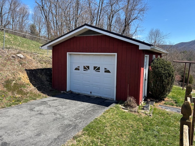 detached garage with driveway and a mountain view