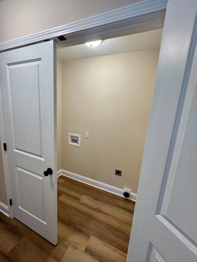 clothes washing area featuring washer hookup, wood finished floors, baseboards, and hookup for an electric dryer