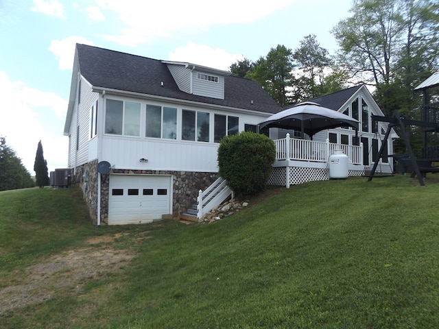 566 Breezy Ridge Rd, Woodlawn, VA 24381 - back of house featuring an attached garage, stone siding, a wooden deck, roof with shingles, and a yard