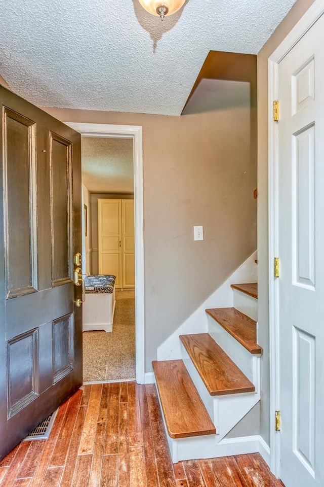 18357 Westwood Dr, Abingdon, VA 24211 - foyer featuring hardwood / wood-style flooring, a textured ceiling, and stairway