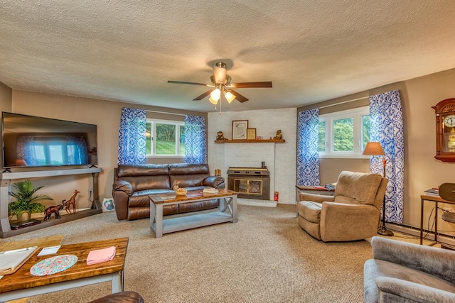 18357 Westwood Dr, Abingdon, VA 24211 - carpeted living area with healthy amount of natural light, a textured ceiling, a ceiling fan, and a baseboard heating unit