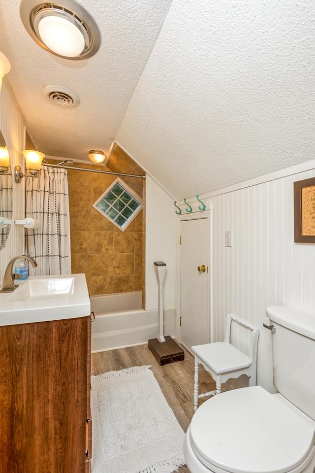 18357 Westwood Dr, Abingdon, VA 24211 - full bath with a textured ceiling, vanity, wood finished floors, lofted ceiling, and shower / bath combo with shower curtain