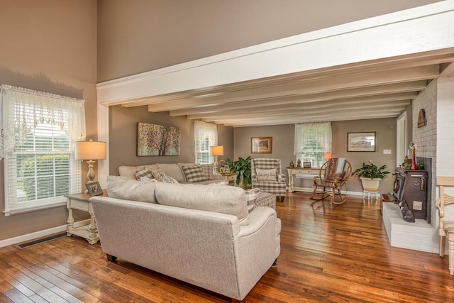 18357 Westwood Dr, Abingdon, VA 24211 - living area with wood-type flooring, beam ceiling, and a wood stove