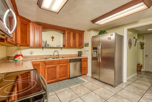 18357 Westwood Dr, Abingdon, VA 24211 - kitchen with appliances with stainless steel finishes, light countertops, light tile patterned floors, a textured ceiling, and brown cabinets