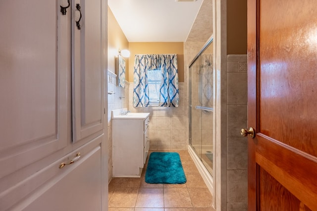 480 N 3rd St, Wytheville, VA 24382 - bathroom with tile patterned floors, a stall shower, tile walls, vanity, and wainscoting