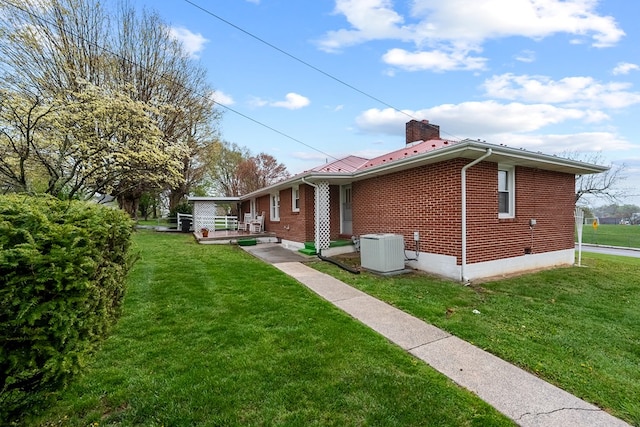 480 N 3rd St, Wytheville, VA 24382 - back of property with central AC unit, brick siding, a chimney, and a lawn