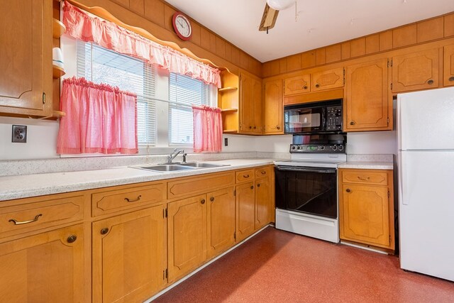 480 N 3rd St, Wytheville, VA 24382 - kitchen with black microwave, freestanding refrigerator, electric stove, a sink, and light countertops