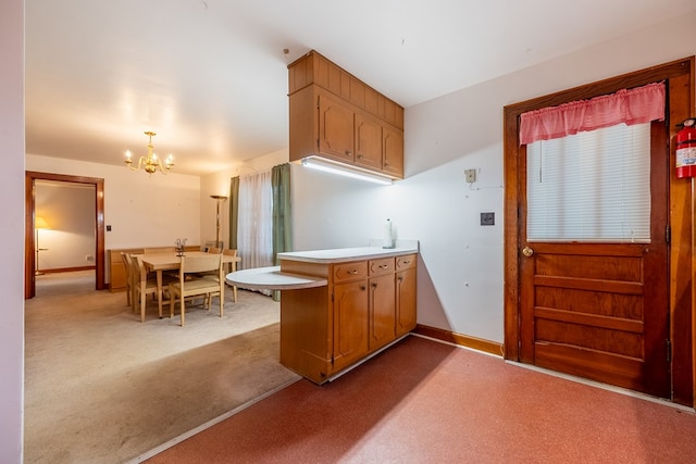 480 N 3rd St, Wytheville, VA 24382 - kitchen with carpet floors, a chandelier, light countertops, and a peninsula