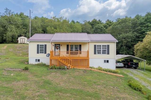 view of front of house with covered porch, metal roof, a shed, an outdoor structure, and a front lawn