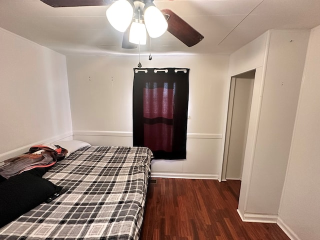 unfurnished bedroom featuring ceiling fan, wood finished floors, and baseboards