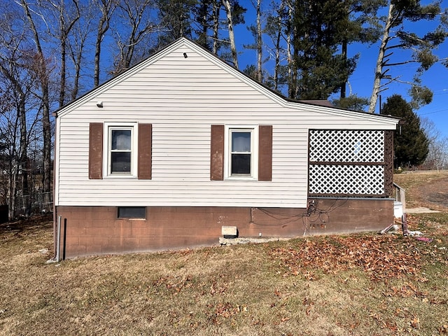 view of side of home featuring a yard