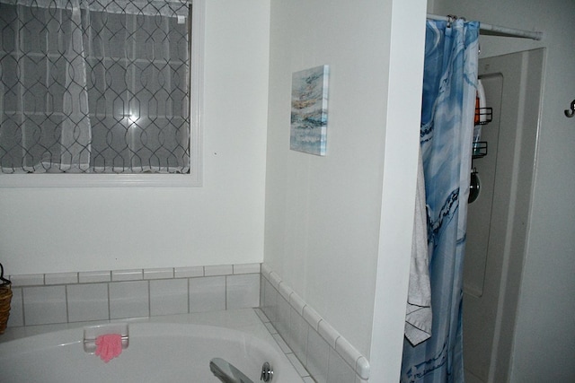 bathroom featuring a shower with curtain and a bathing tub