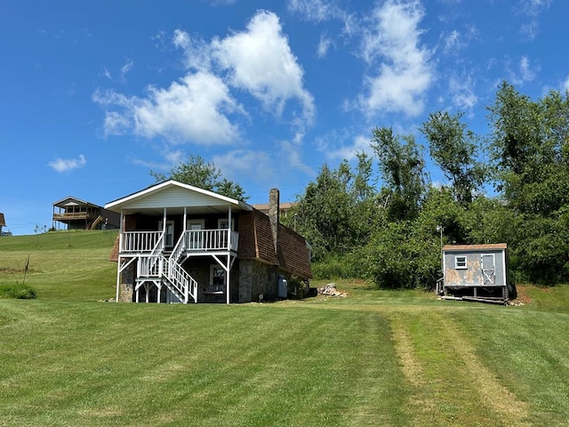 542 Volunteer Rd, Fancy Gap, VA 24328 - rear view of property with stairs, a yard, and a shed