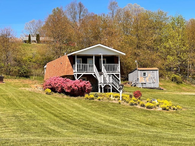 542 Volunteer Rd, Fancy Gap, VA 24328 - view of front facade with covered porch, a front yard, a shed, and stairway